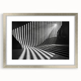 Textured abstract art print in muted gray and silver tones, framed with a silver mat, ideal for modern bedroom ambiance.