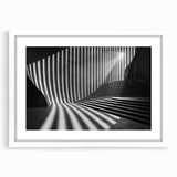 Abstract art print of geometric tunnel design in black and white, framed with a white mat.