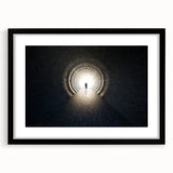 Abstract art print of geometric tunnels in black and white, framed with a black mat.