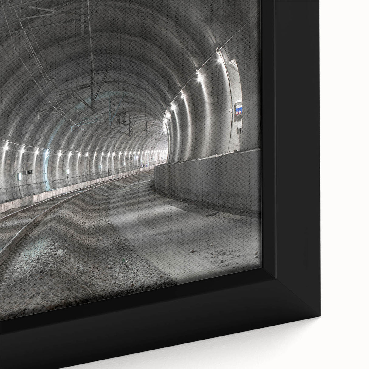 Close-up of a black textured wall art featuring colorful abstract designs on a framed canvas.