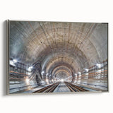 Framed canvas of a vintage poster art depicting colorful, abstract landscape tunnels in muted black and silver tones.