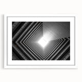 Abstract art print featuring geometric patterns in black and white, framed with a white mat.