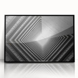 Large abstract wall art depicting a tunnel design in black and white tones on a framed acrylic.