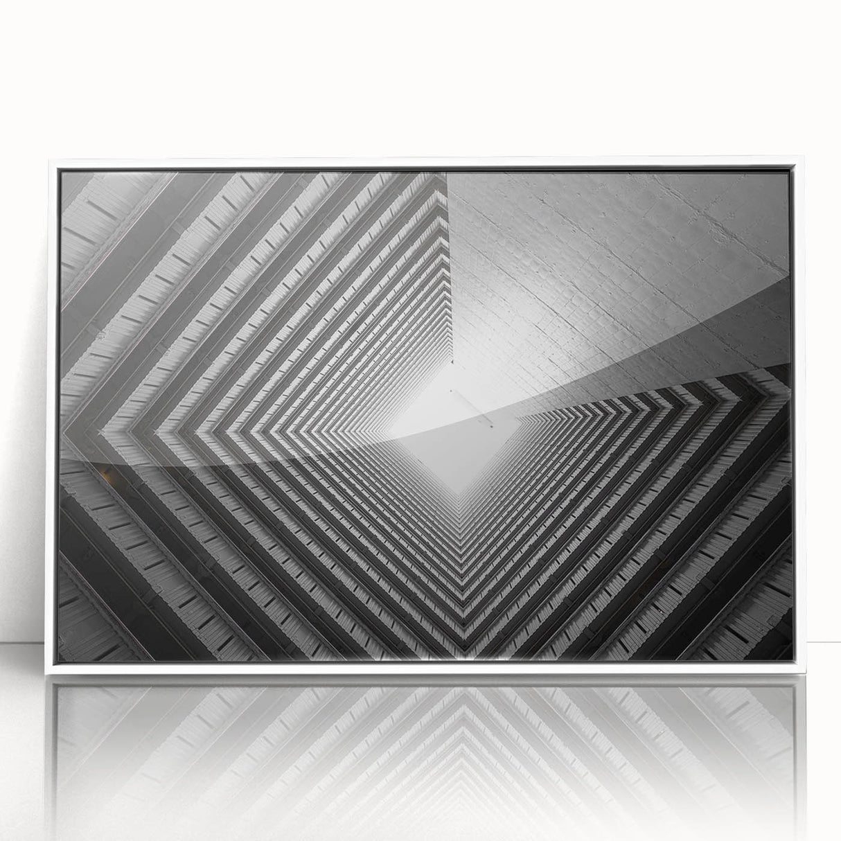 Art deco poster featuring geometric patterns and sharp lines in black and white, acrylic print framed in white.