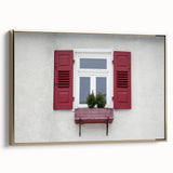 Framed canvas featuring a vintage poster of a colorful landscape with black architectural elements.