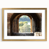 Textured abstract art print in muted gold and white hues, framed with a gold mat, ideal for bedroom decor.