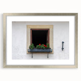 Abstract art print featuring geometric patterns in muted gray and blue tones, framed with a silver mat.