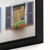 Close-up of a black framed canvas featuring a colorful, textured depiction of architectural windows.