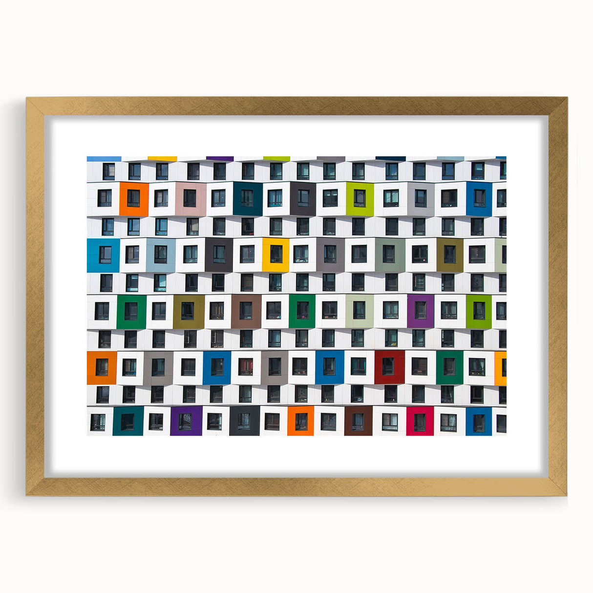 Textured abstract art print featuring irregular patterns in earthy tones, framed in gold, suitable for bedroom decor.