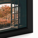 Close-up of textured black wall art featuring a colorful, abstract window design on a framed canvas.