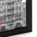 Close-up of black wall art featuring a textured window design with colorful accents on a framed canvas.