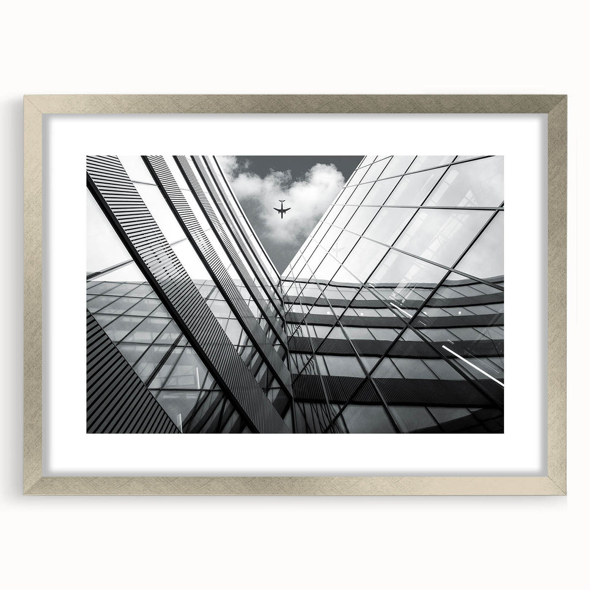 Abstract art print featuring geometric shapes in muted gray and silver tones on a framed canvas.