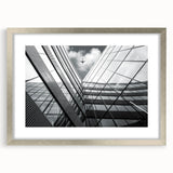 Abstract art print featuring geometric shapes in muted gray and silver tones on a framed canvas.