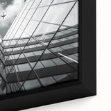 Close-up of a black framed canvas featuring an abstract, textured design with colorful elements, ideal for living room decor.