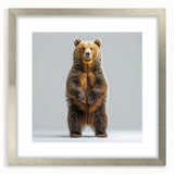 Framed wall art featuring a striking black bear design, elegantly displayed with a silver frame and mat, perfect for wildlife enthusiasts and home decor.