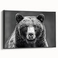 Framed wall art featuring a striking black bear design on canvas, showcasing intricate details and textures. The artwork is presented in a modern black frame, perfect for nature enthusiasts.