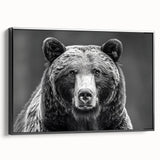 Framed wall art featuring a striking black bear design on canvas, showcasing intricate details and textures. The artwork is presented in a modern black frame, perfect for nature enthusiasts.