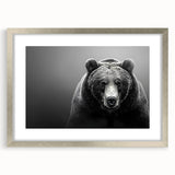 Framed wall art featuring a striking black bear design in a silver frame, showcasing intricate details and a stylish mat, perfect for nature enthusiasts.