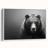 Framed canvas wall art showcasing a striking black bear design, elegantly displayed with a white frame, perfect for nature-inspired home decor.