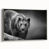 Framed wall art featuring a striking black bear design on a textured canvas, showcasing a silver frame from a side view, perfect for nature enthusiasts.