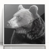 Framed wall art featuring a striking black bear design on an acrylic surface, showcasing a modern aesthetic with a white frame, ideal for nature-themed decor.