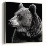 Framed wall art showcasing a striking black bear design on canvas, featuring a sleek silver frame and a side view perspective, perfect for nature lovers’ decor.