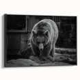Framed wall art showcasing a striking black bear design on canvas, featuring a sleek black frame and side view display, perfect for nature-themed decor.