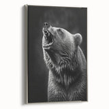 Framed wall art featuring a striking black bear design on textured canvas, elegantly displayed with a silver frame, adding a modern touch to any decor.