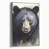 Framed wall art featuring a black bear design on textured canvas, showcased with a sleek silver frame, ideal for nature-themed home decor and wildlife enthusiasts.