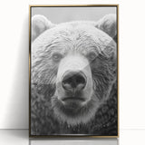Framed wall art featuring a striking black bear design with gold accents, displayed in an elegant acrylic frame, perfect for nature-themed decor.