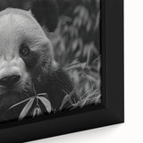 Close-up of a framed canvas wall art featuring a playful panda bear design, showcasing vibrant colors and intricate details, perfect for children's room decor.