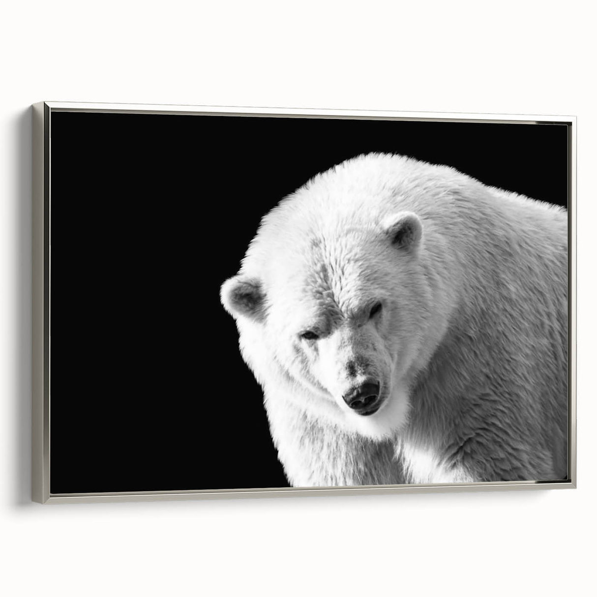 Framed wall art featuring a polar bear design on a textured canvas, showcasing a silver frame. Ideal for adding a contemporary wildlife touch to home decor.