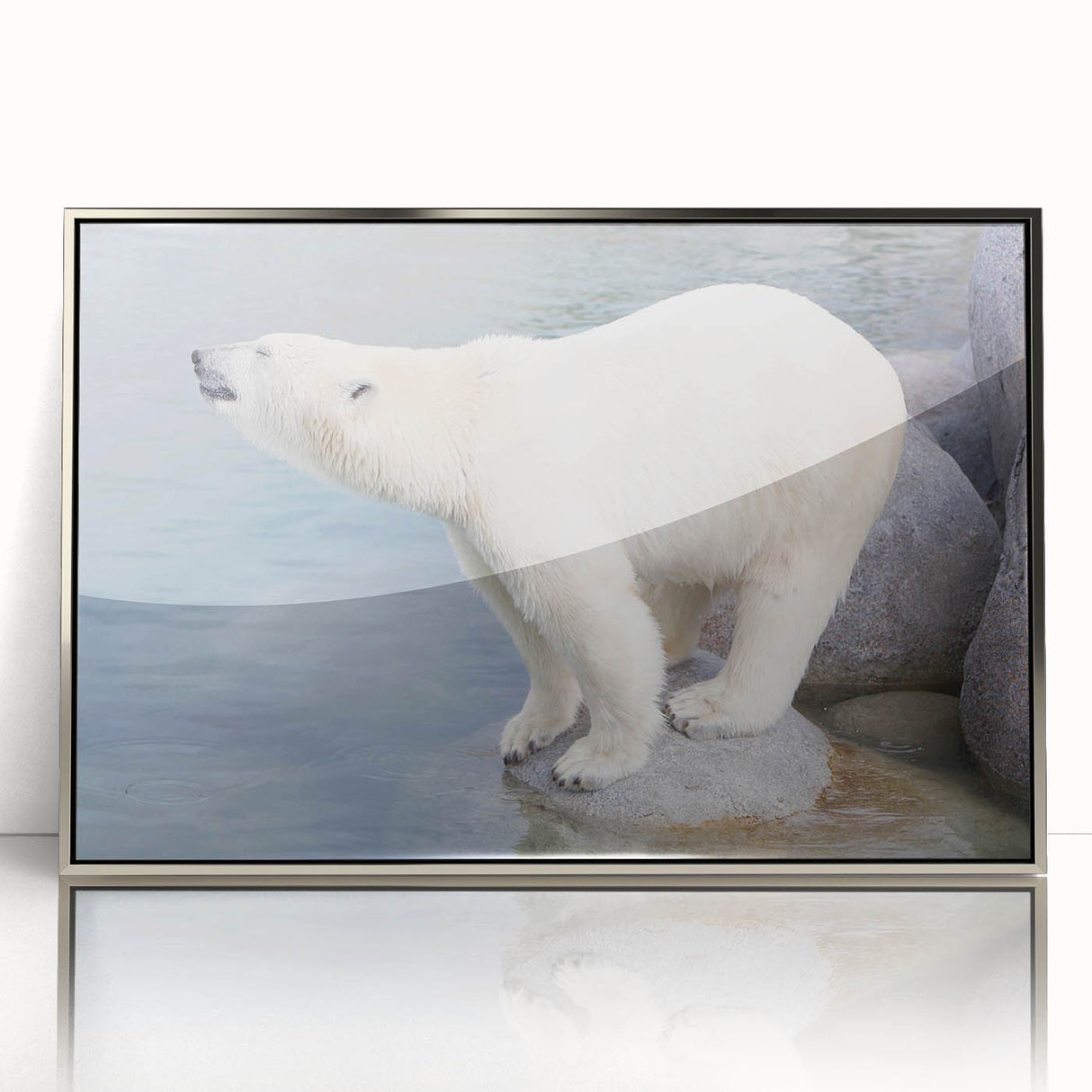 Framed wall art showcasing a striking polar bear design in acrylic, with a sleek silver frame, ideal for enhancing modern home decor. The artwork captures the essence of wildlife, making it a perfect statement piece for animal lovers.