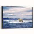 Framed wall art showcasing a polar bear design on a black background, featuring a side view of the canvas. Ideal for wildlife-themed decor, this piece adds a touch of nature to any room.