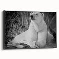 Framed canvas wall art featuring a striking polar bear design in black, showcasing its side profile against a minimalist backdrop, perfect for modern decor.