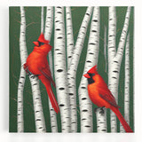 Vibrant stretched canvas wall art featuring a pair of bright red cardinals perched on a snowy branch, ideal for adding a touch of nature to any home decor.