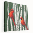 Stretched canvas wall art showcasing vibrant red cardinals perched on branches, surrounded by lush green leaves, ideal for nature-themed decor and bird enthusiasts.