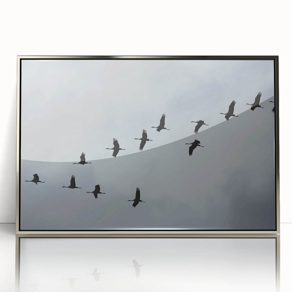 Framed wall art featuring a silver-accented crane design, elegantly displayed in an acrylic frame. Ideal for modern home decor, adding a touch of sophistication.