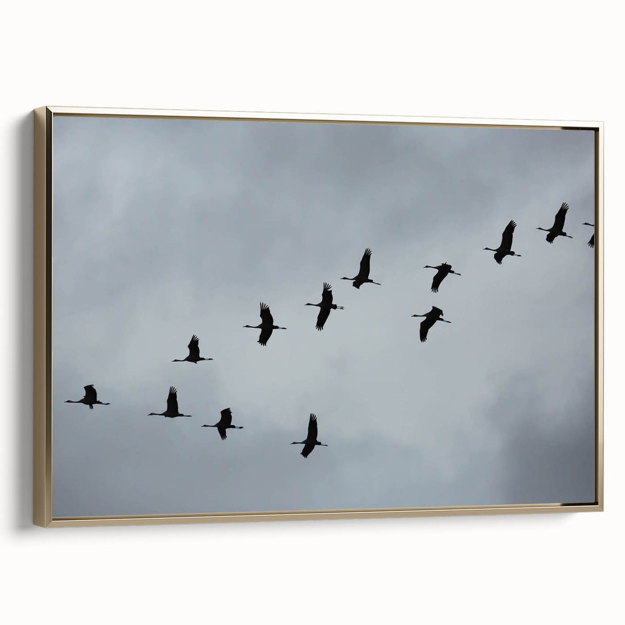 Framed wall art showcasing a sophisticated crane design on canvas, featuring a gold frame, perfect for enhancing modern decor with elegance.