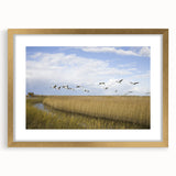 Framed wall art featuring an elegant crane design in gold, set against a neutral background. Ideal for adding a touch of sophistication to home décor.