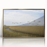 Framed wall art featuring an elegant crane design in gold accents, set against a sleek acrylic background, perfect for modern home decor. This artwork adds a touch of sophistication to any room with its minimalist style and vibrant details.