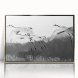 Framed wall art featuring a silver-accented crane design, showcasing elegant birds in flight against a soft backdrop, ideal for modern decor and nature enthusiasts.