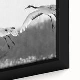 Close-up of a framed canvas wall art depicting elegant cranes in a serene natural setting, showcasing intricate details and soft colors, perfect for home decor.