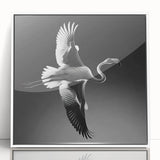 Framed wall art featuring a colorful flamingo design, showcasing vibrant pink and teal hues against a white background, perfect for modern decor.