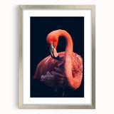 Framed wall art featuring a vibrant flamingo design, enclosed in a silver frame with a mat. Ideal for enhancing modern decor with a tropical touch.