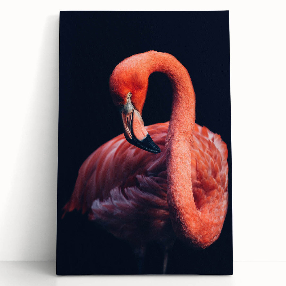 Stretched canvas wall art featuring a vibrant flamingo design with bright pink hues, leaning against a wall, perfect for tropical-themed decor.