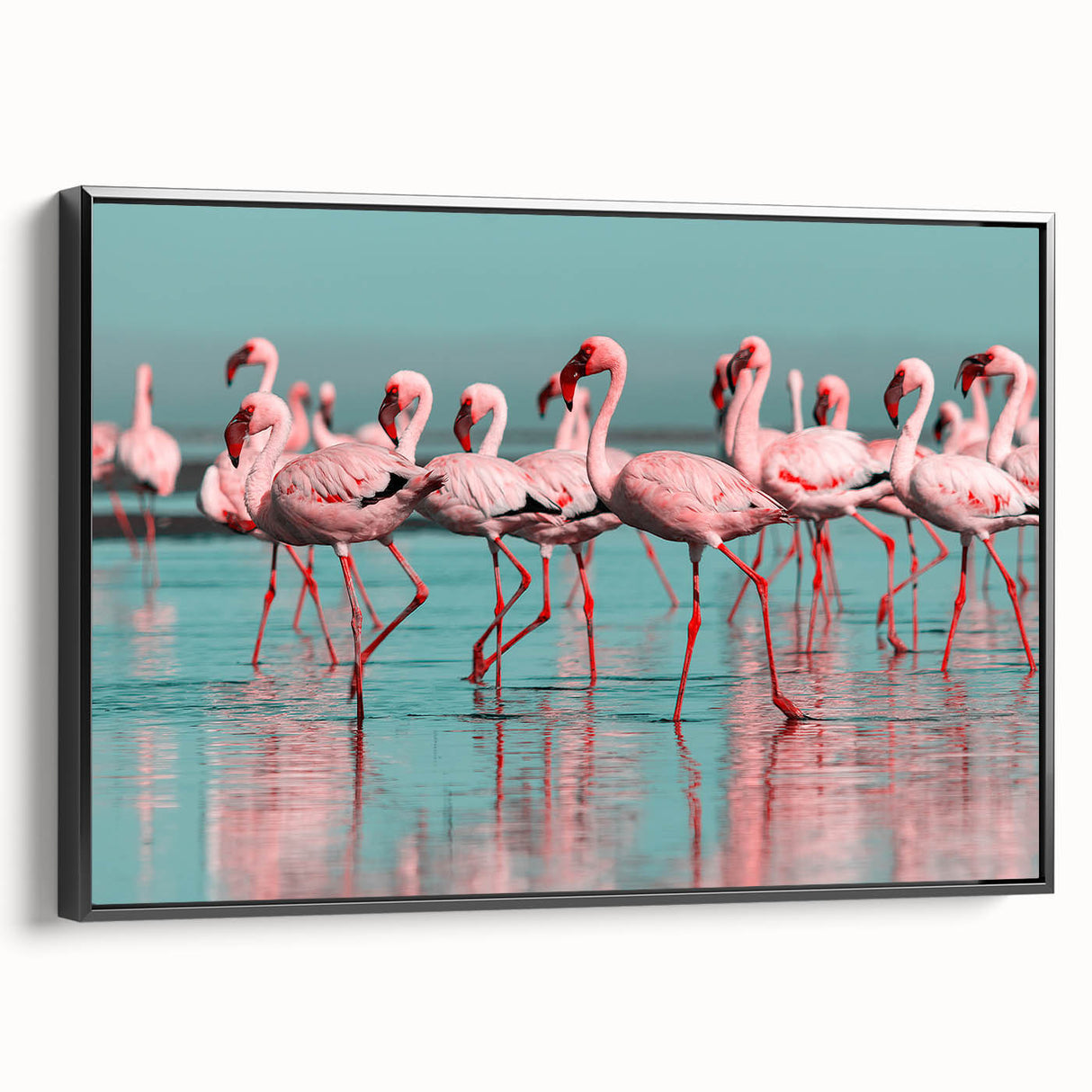 Framed canvas wall art featuring a vibrant flamingo design in shades of pink and green, displayed against a sleek black frame, ideal for modern decor.