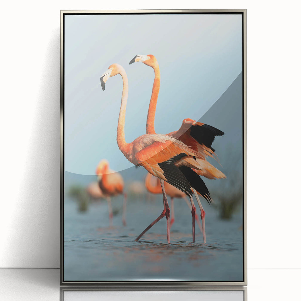 Framed wall art featuring a vibrant flamingo design with a sleek silver frame, showcasing tropical colors and modern aesthetics, perfect for enhancing home decor.