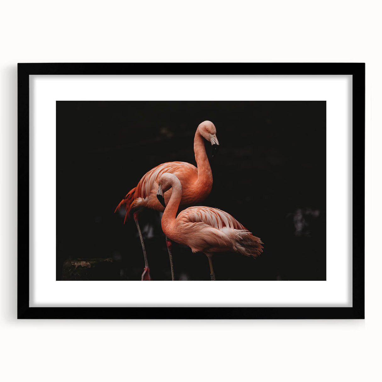 Framed wall art featuring a vibrant flamingo design in pink tones, set against a sleek black frame with a mat for an elegant display in modern decor.
