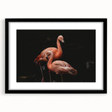 Framed wall art featuring a vibrant flamingo design in pink tones, set against a sleek black frame with a mat for an elegant display in modern decor.
